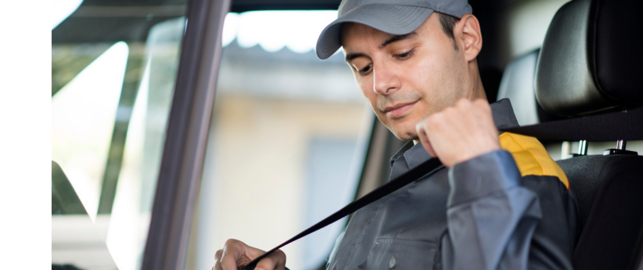 Driver putting seatbelt on for safety - MICHELIN Connected Fleet
