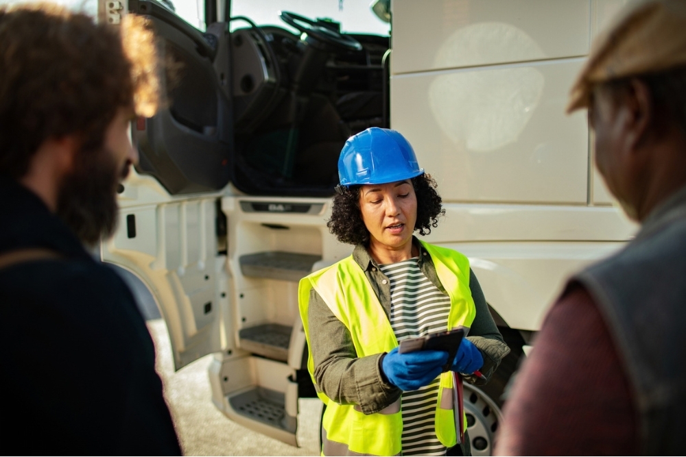female fleet manager talking to drivers
