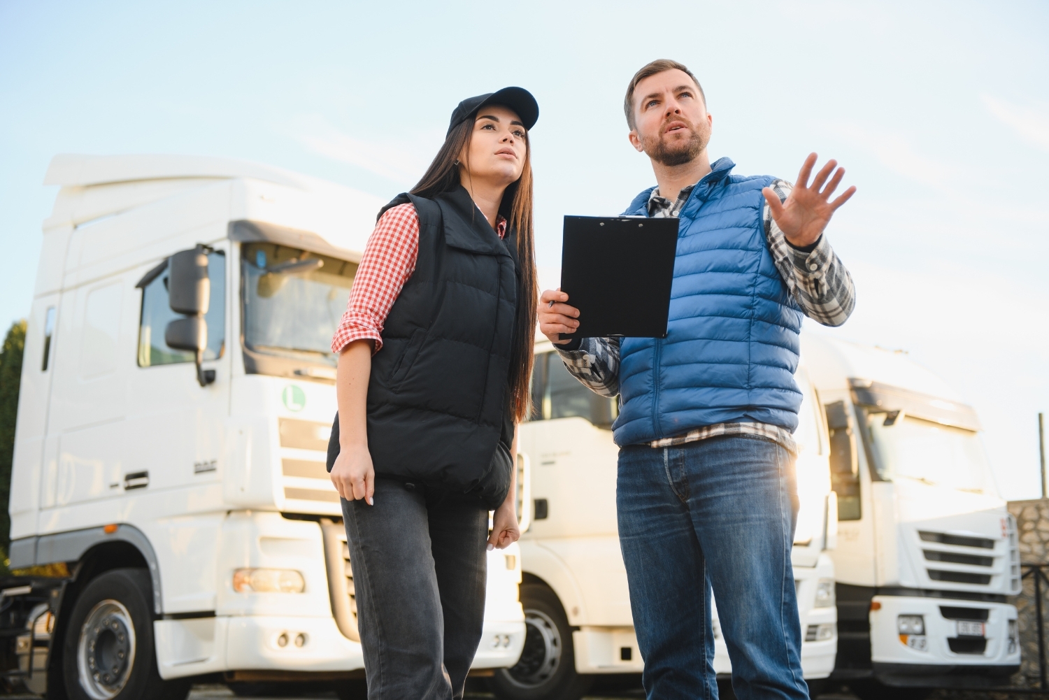 fleet manager with clipboard next to employee
